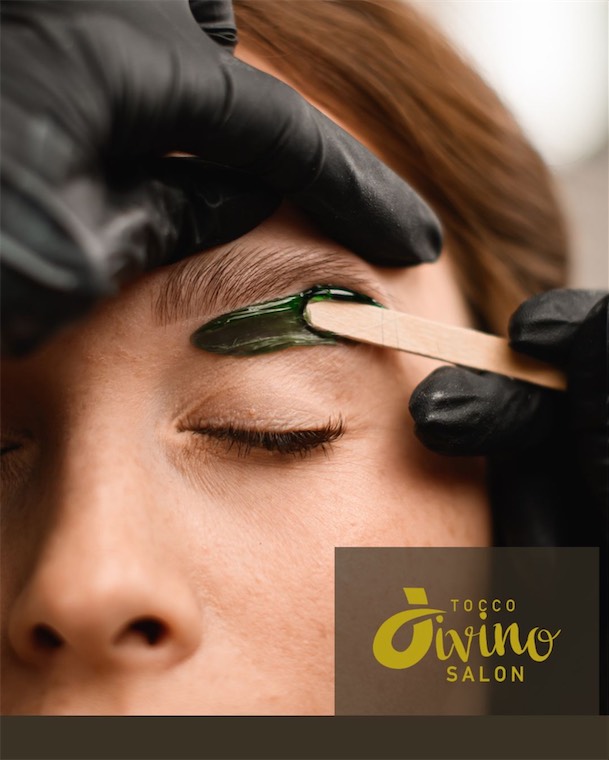 Eyebrow waxing with a wooden applicator