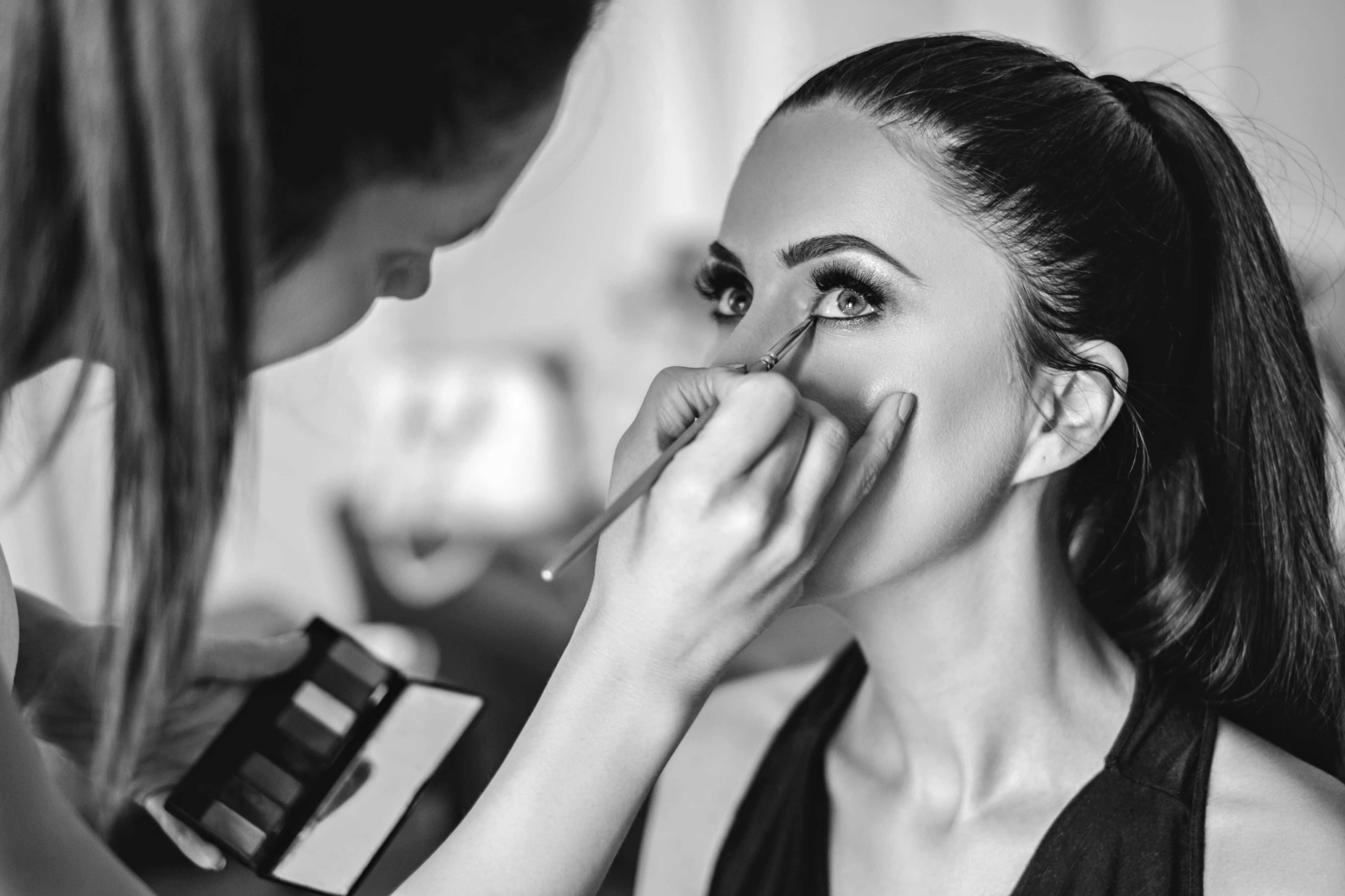 Makeup artist applying eyeshadow to a client