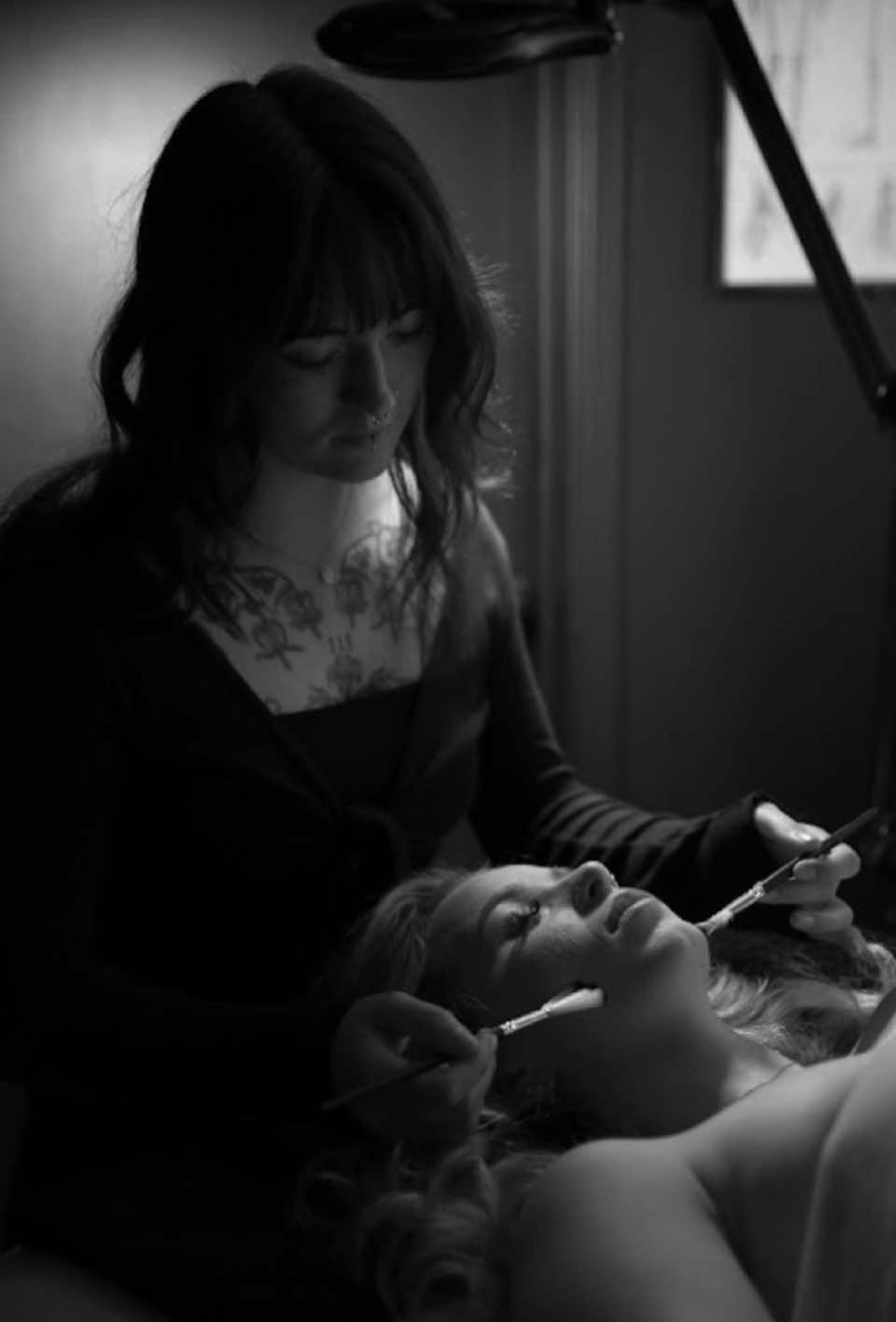 Esthetician performing a facial for a relaxed client