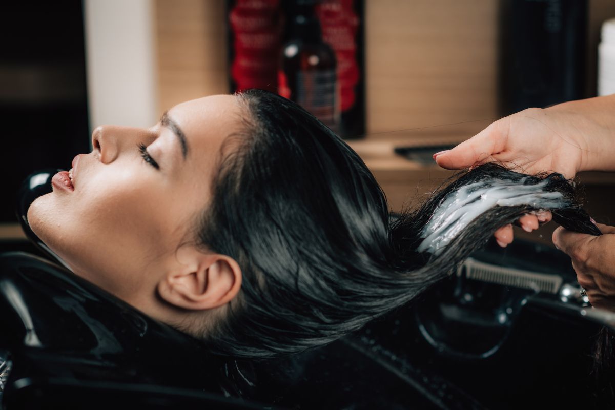 Client receiving a conditioning treatment at the shampoo bowl