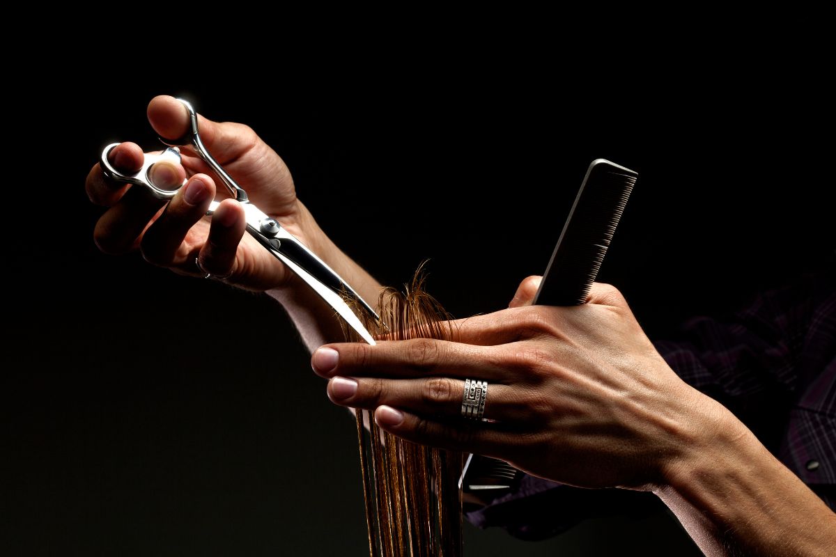 Stylist cutting hair with professional shears