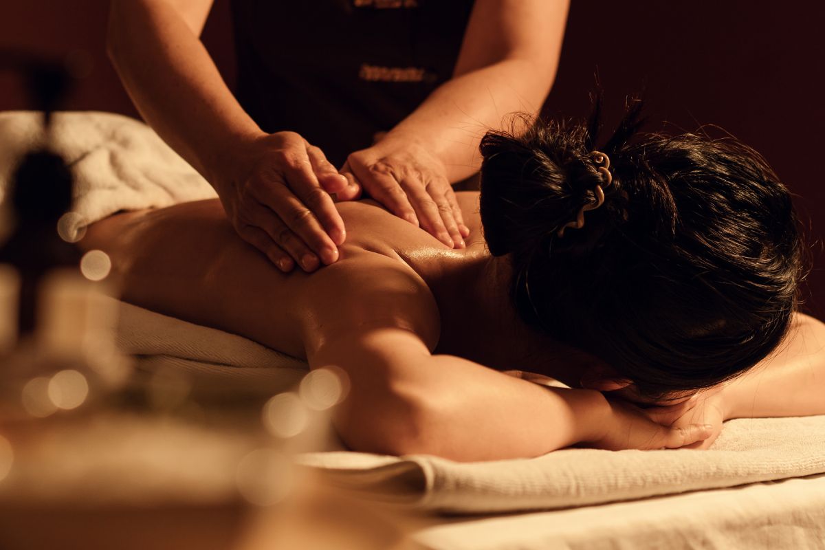 Relaxing back massage in a warmly lit spa room
