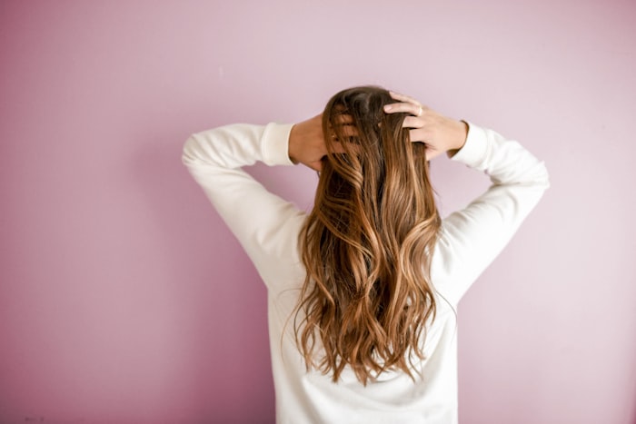 Woman running her hands through long, healthy hair