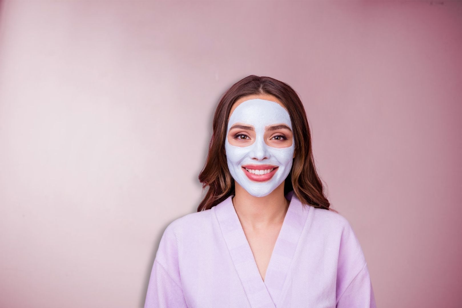 Smiling woman wearing a facial mask and spa robe